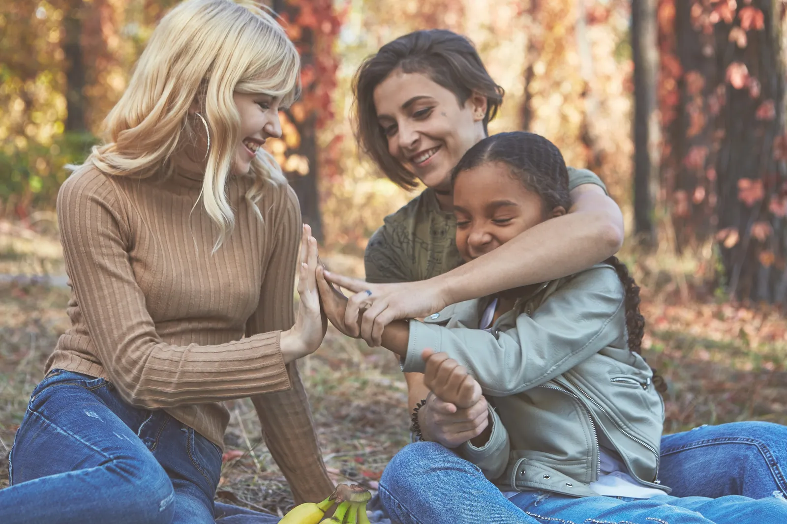A mother and daughter laughing outdoors