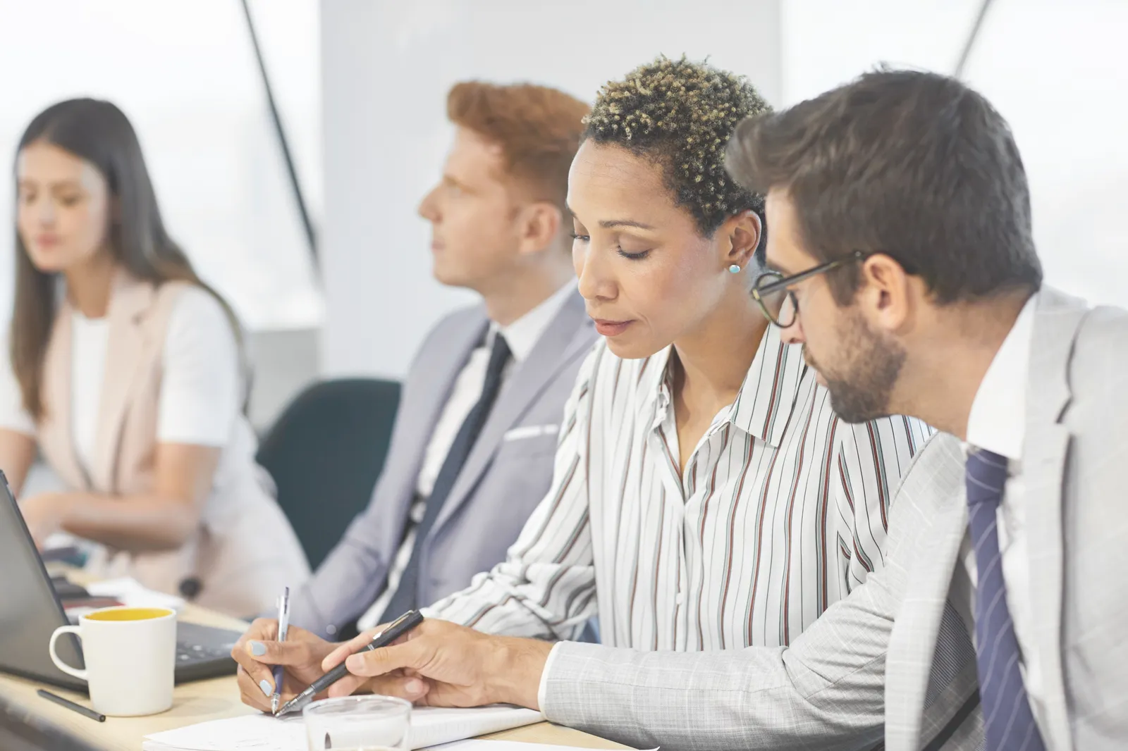 A payroll team reviewing paperwork together